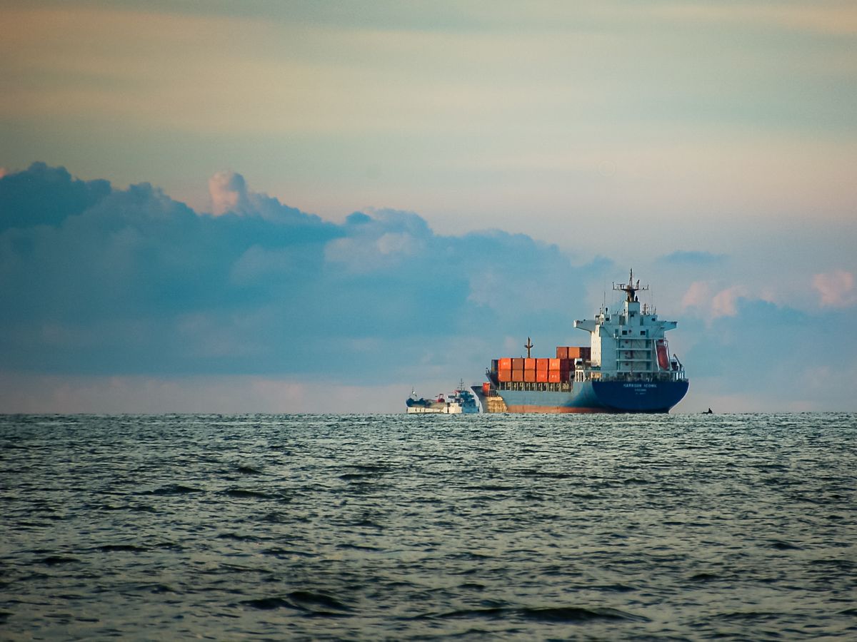 Container vessel at a port at dusk